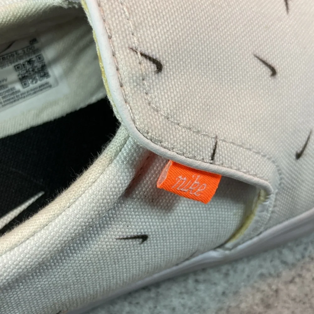 Size 9.5 Nike white slip on surfer skater‎ style with swooshes all over. 5